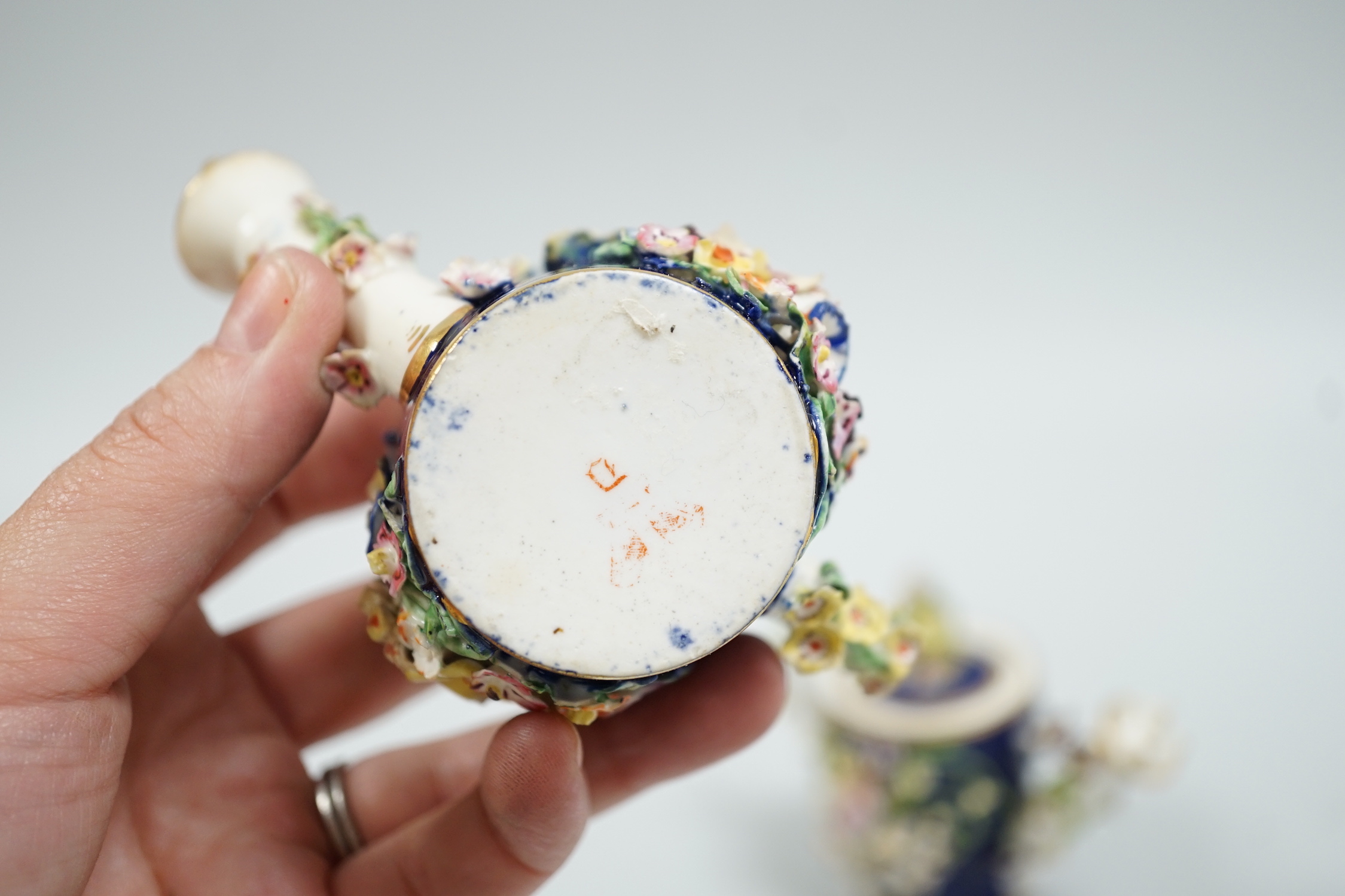 Toy porcelain. Two Bloor Derby flower encrusted rosewater sprinklers, each modelled as a watering can, c.1825, red printed marks, 9cm high